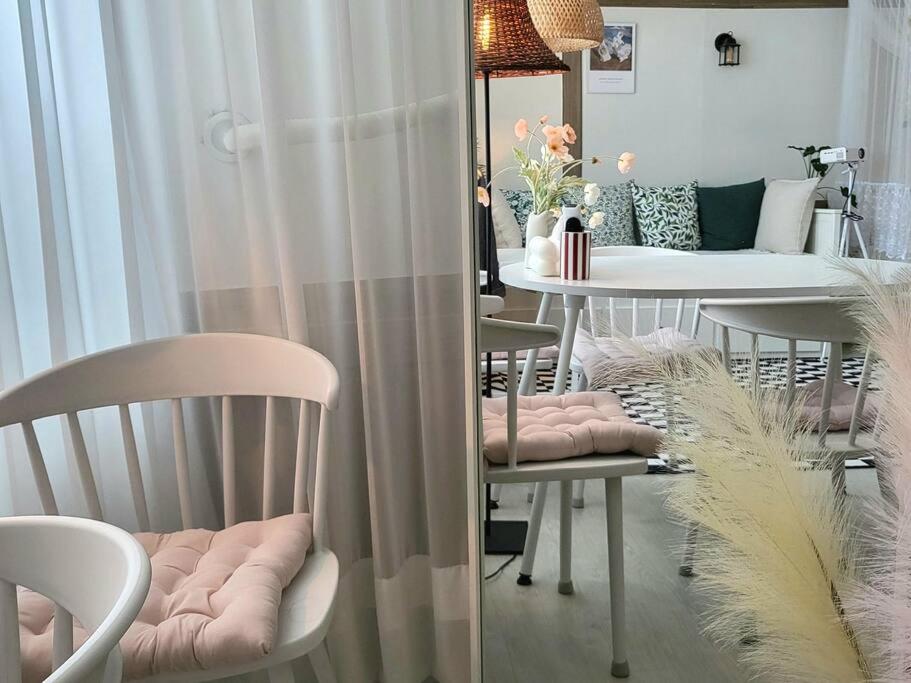 a room with chairs and a table with a dining room at Cottenbeach2 in Sokcho