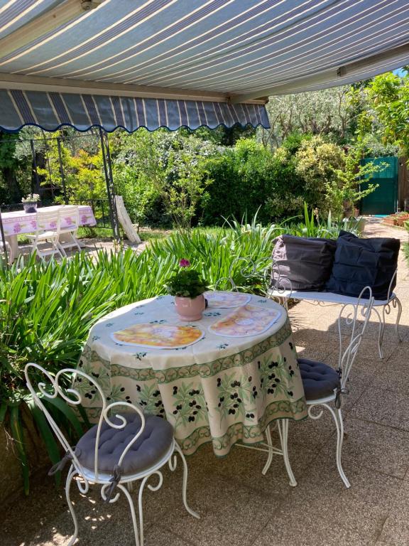 une table et des chaises assises sous un parasol dans l'établissement Villadélie, à La Londe-les-Maures