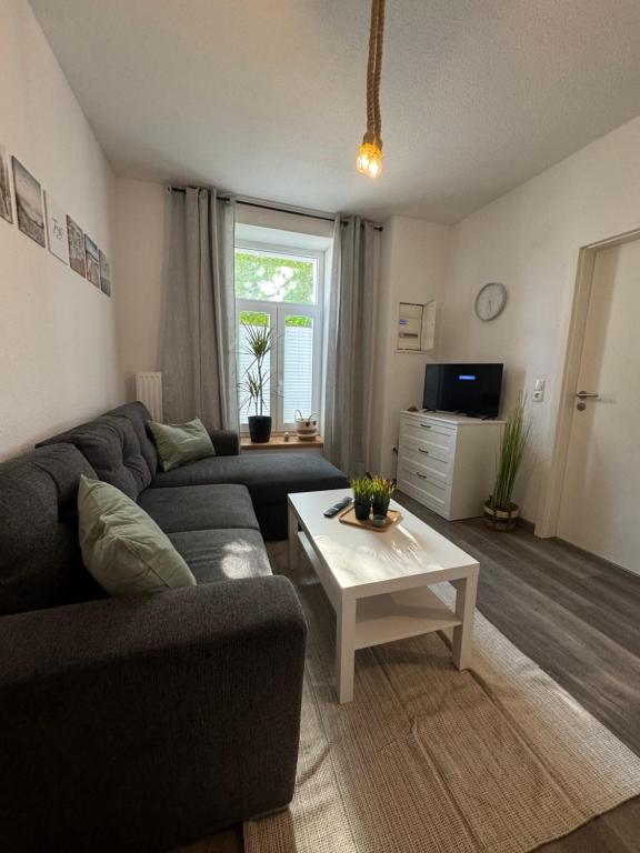 a living room with a couch and a table at FeWo Krabbe in Wilhelmshaven