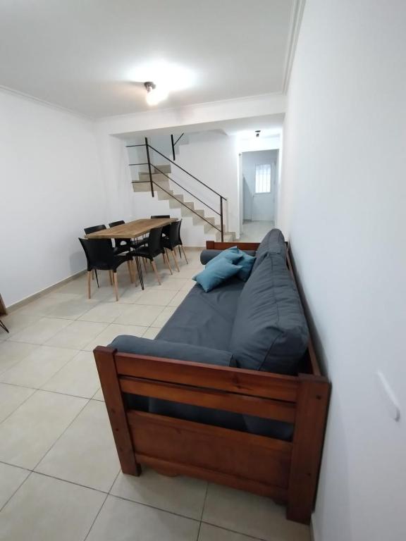 a bed in a room with a table and chairs at Hermoso Duplex en San Miguel in General Sarmiento