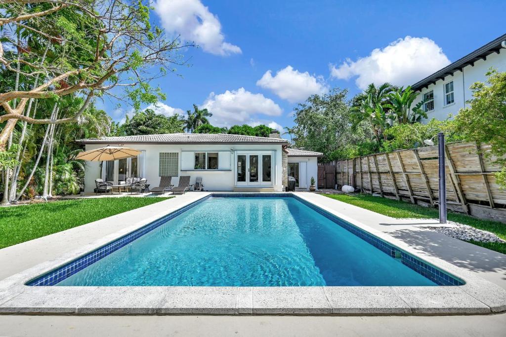 a swimming pool in front of a house at Summer Estate - Pool Parking & Prime Location in Miami