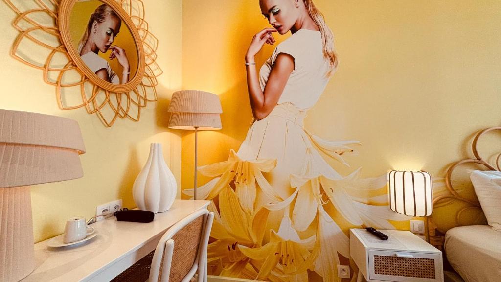 een vrouw in een witte jurk in een kamer met een spiegel bij Le Glam's Hotel in Parijs