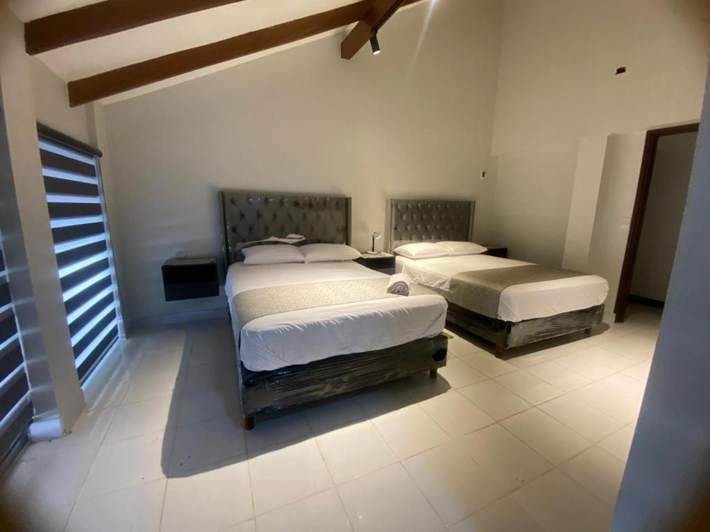 a bedroom with two beds in a room at Amaca Hostal in Santa Cruz de la Sierra