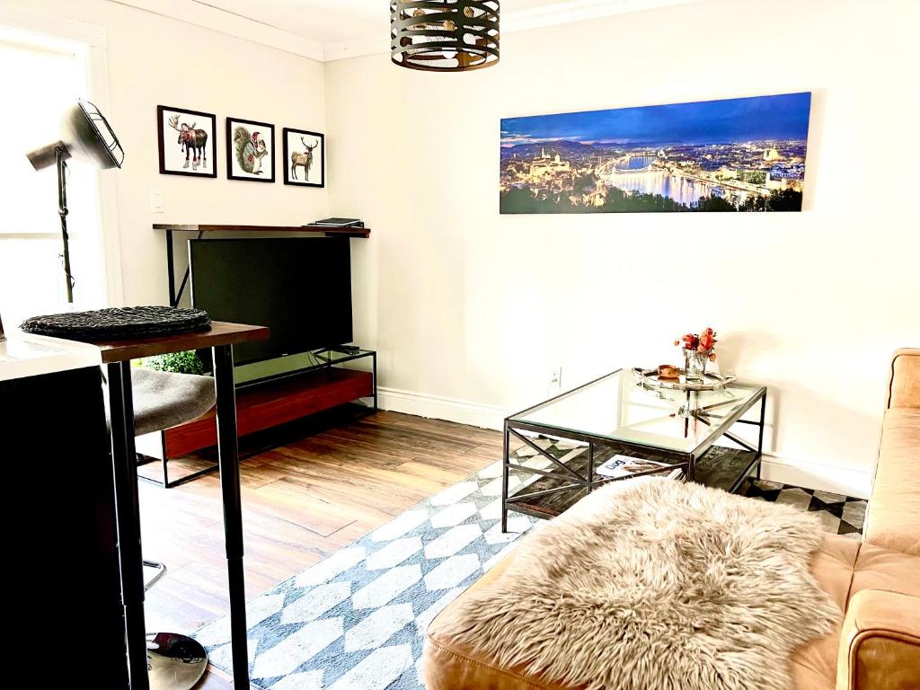 a living room with a couch and a table at Budapest - Heritage Tay Basin Water View in Perth