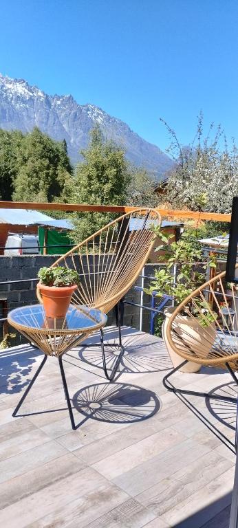 two chairs sitting on top of a wooden deck at Cabañas Seru in El Bolsón