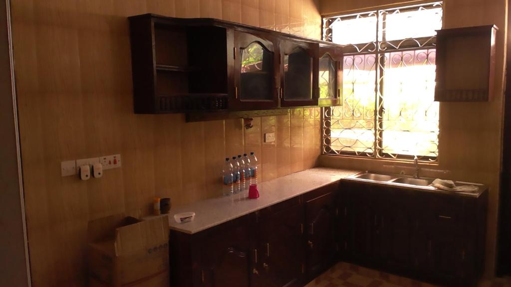 a kitchen with a sink and a window at Fumba House BnB in Fumba
