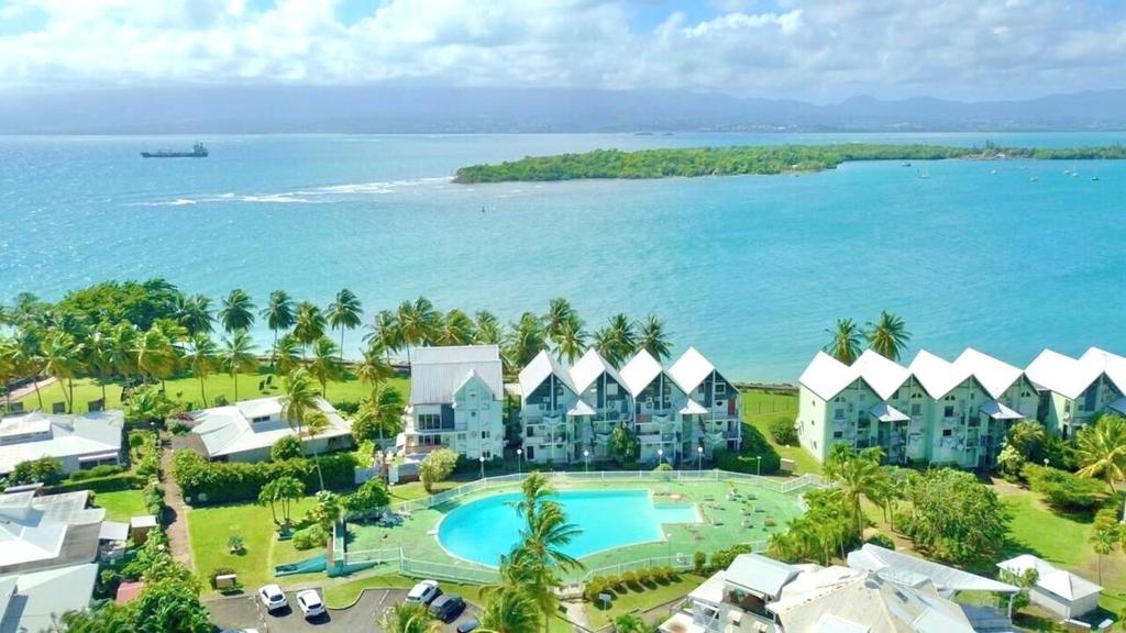 an aerial view of the resort and the ocean at Appartement en résidence avec piscine in Le Gosier