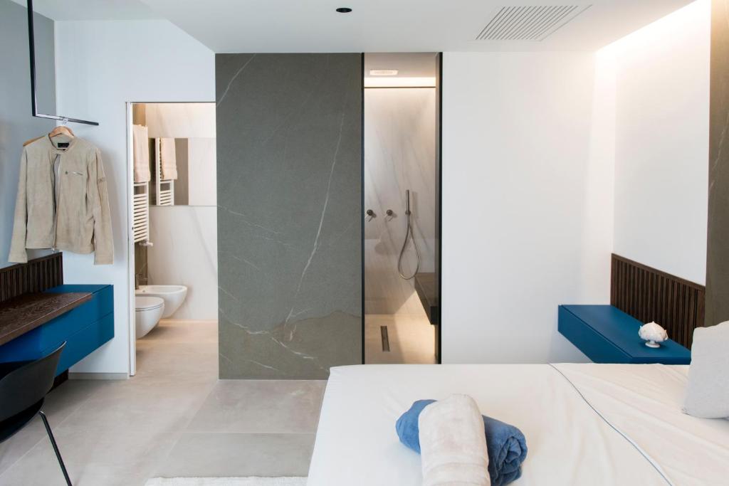 a bathroom with a shower and a bed in a room at Aschitelli luxury retreat in Polignano a Mare