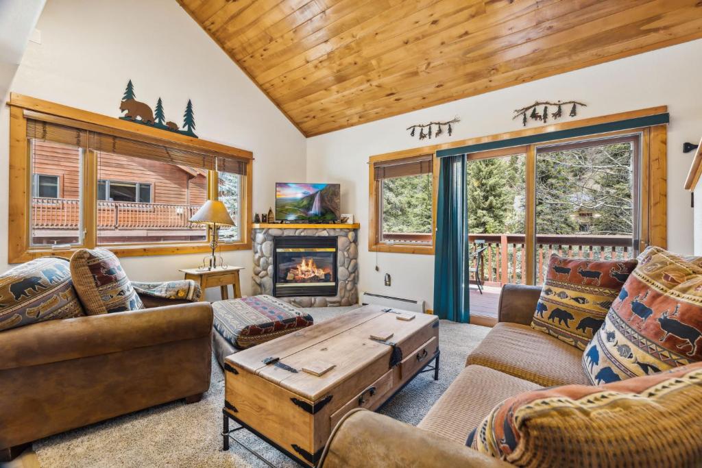 a living room with couches and a fireplace at Bugle Pointe A01 by Estes Park Condos in Estes Park