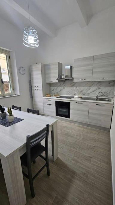 a kitchen with a table and a counter top at Casa Mia in Scilla