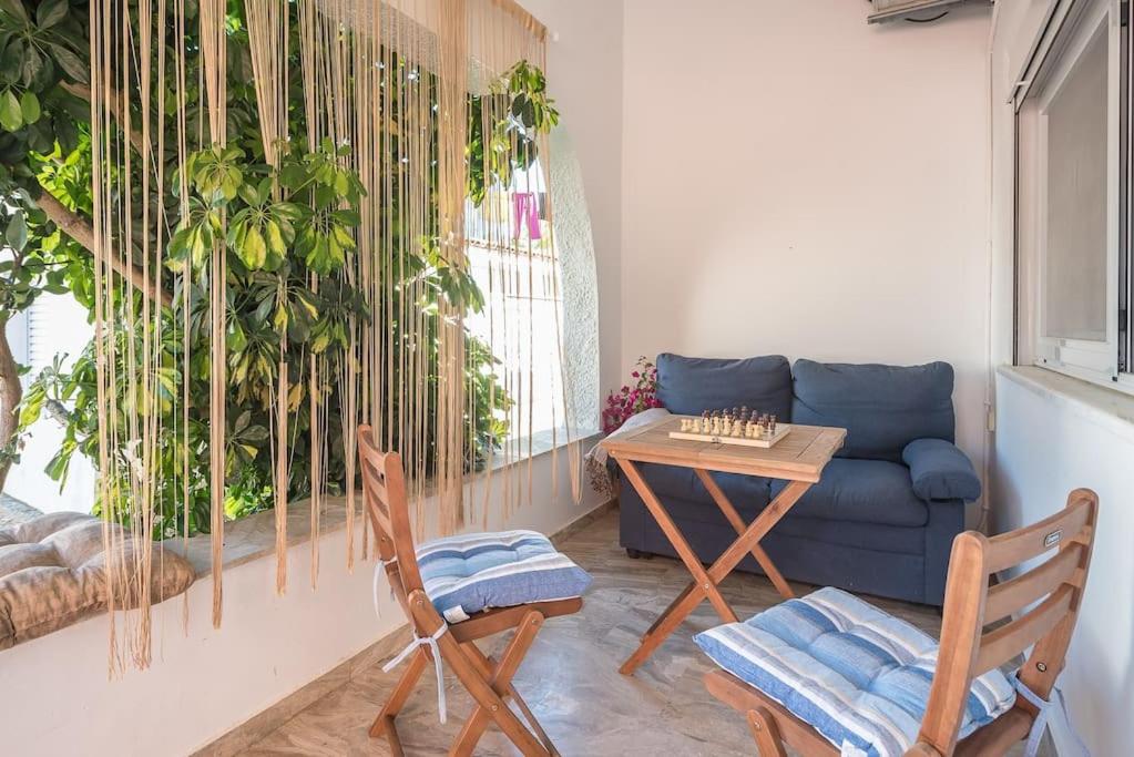 a living room with a couch and a table and chairs at Stardust sanctum hideaway in Káto Panayía