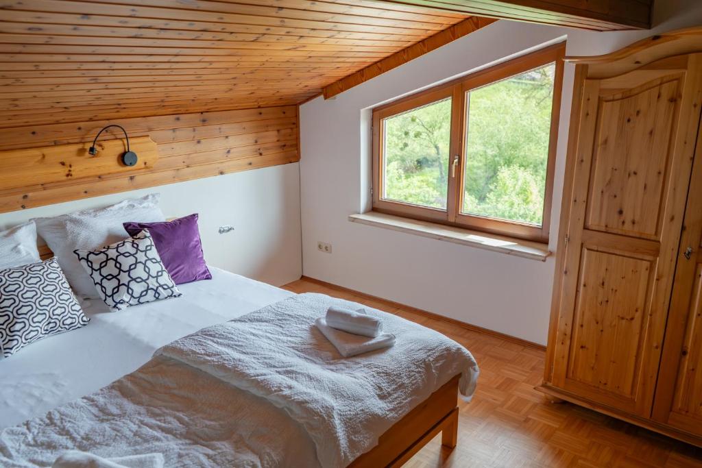 a bedroom with a large bed with a window at S.A.W. Rooms in Schiefling am See