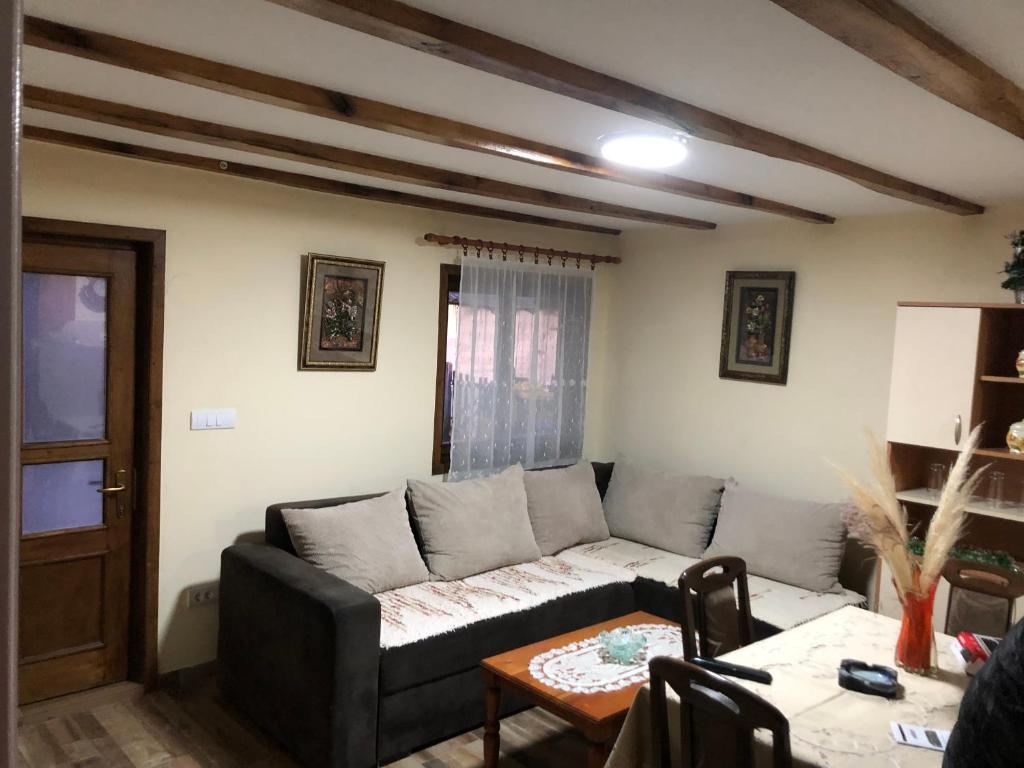 a living room with a couch and a table at Seoska kuca Seoce in Požega