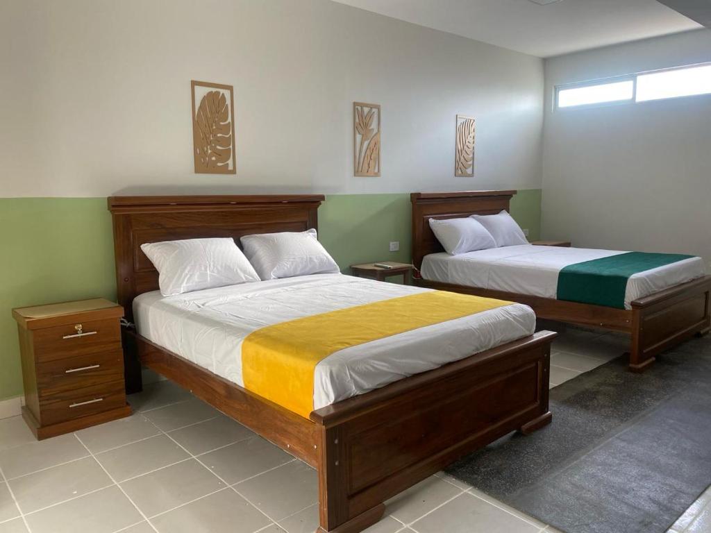 two beds in a room with two beds sidx sidx sidx sidx at Amaca Hostal in Santa Cruz de la Sierra