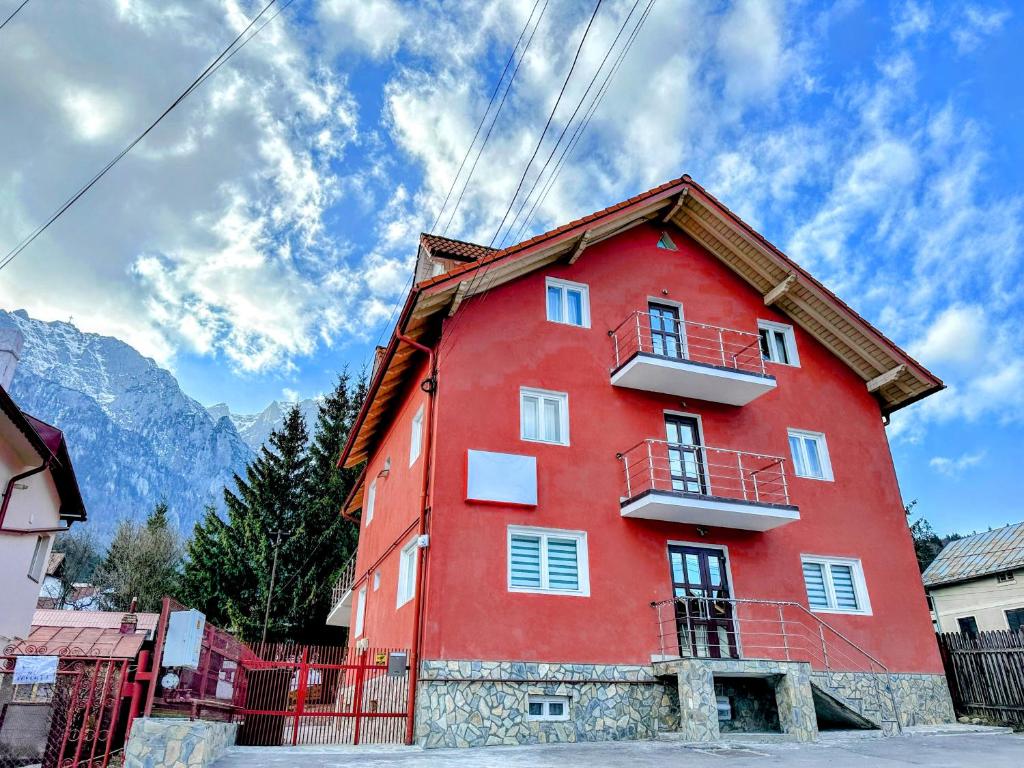 a red building with a red roof at Valea Albă View - SELF CHECK-IN in Buşteni