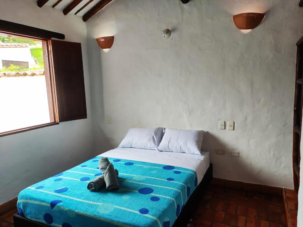 Postel nebo postele na pokoji v ubytování La Casa Del Toche Barichara