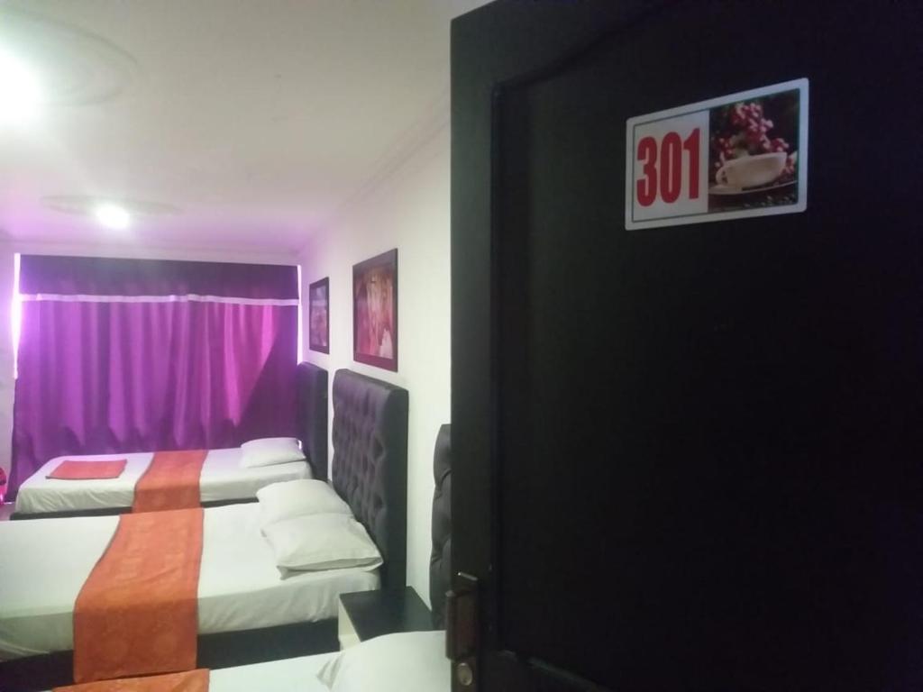 Postel nebo postele na pokoji v ubytování HOTEL EJE DEL CAFÉ