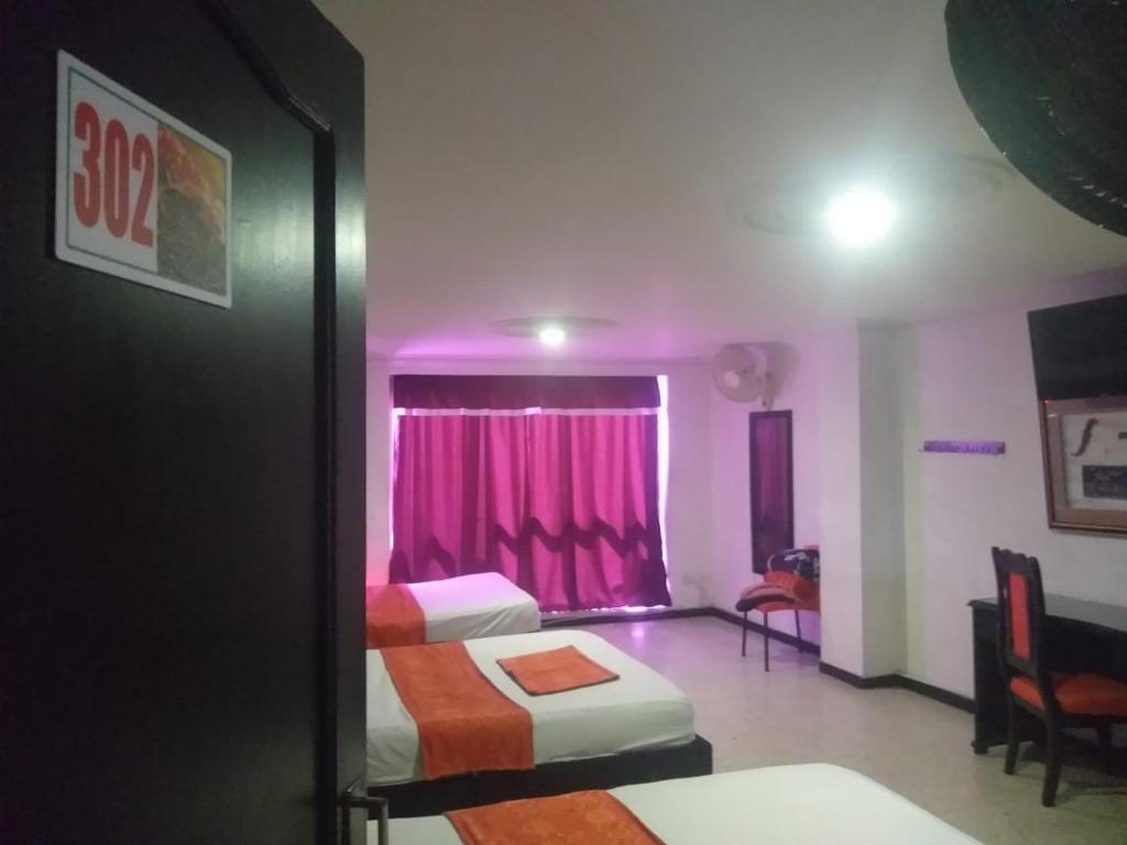 Postel nebo postele na pokoji v ubytování HOTEL EJE DEL CAFÉ