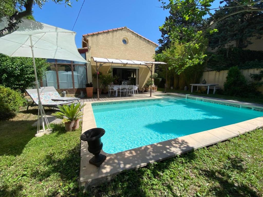 a swimming pool in the yard of a house at Le Cezanne in Aix-en-Provence