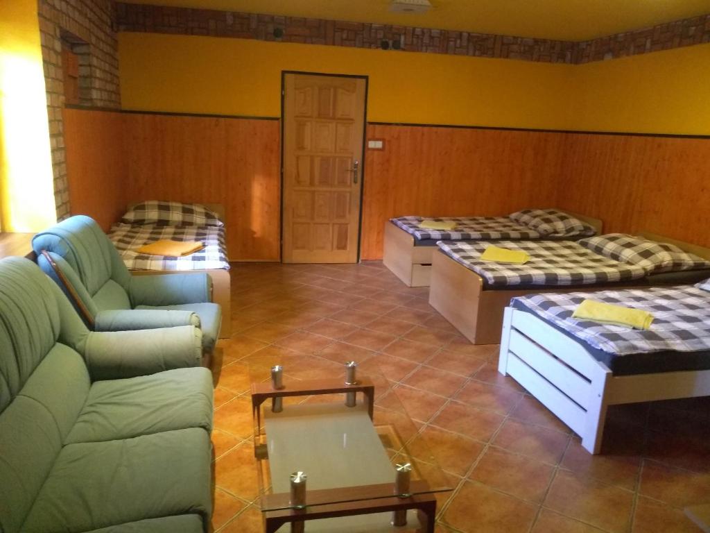 オストラヴァにあるMAT ubytováníのリビングルーム(ベッド2台、ソファ付)