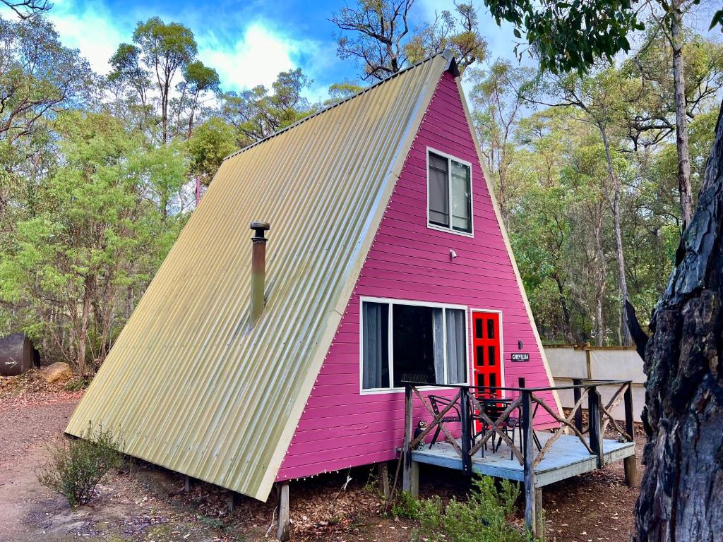 a pink house with a yellow roof at Grevillea at Porongurup Chalets in Porongurup