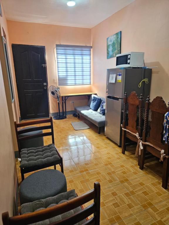 a living room with a refrigerator and a couch at Mel's Place 2BR Apartment Unit2 in Batangas City in Batangas City