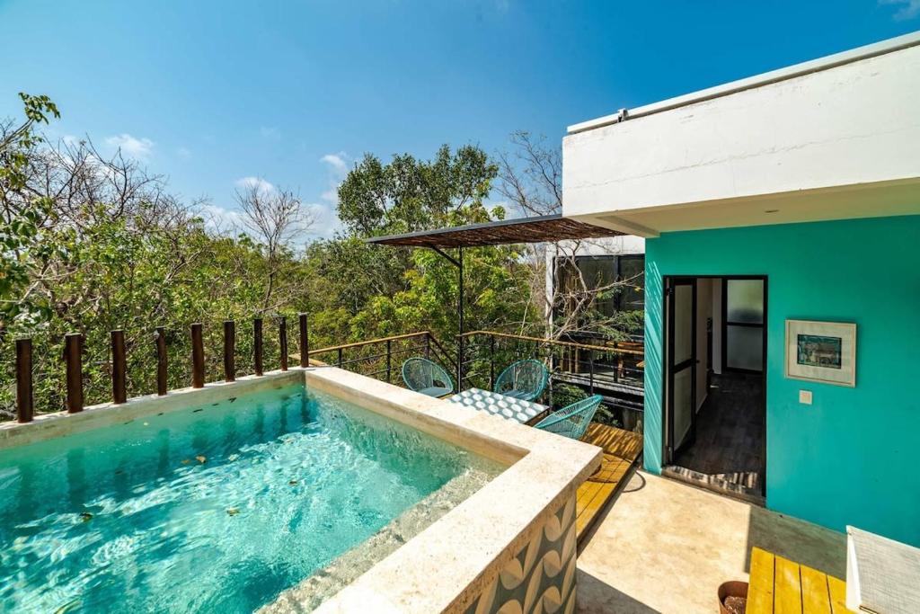 a swimming pool in the backyard of a house at CHIC 3-Levels at MUN - Rooftop Deck - Pool in Tulum