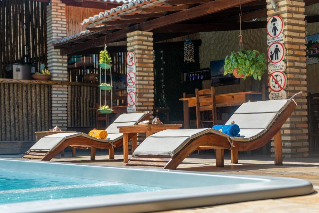 2 ligstoelen naast een zwembad bij Casa do velejador in Barra Grande