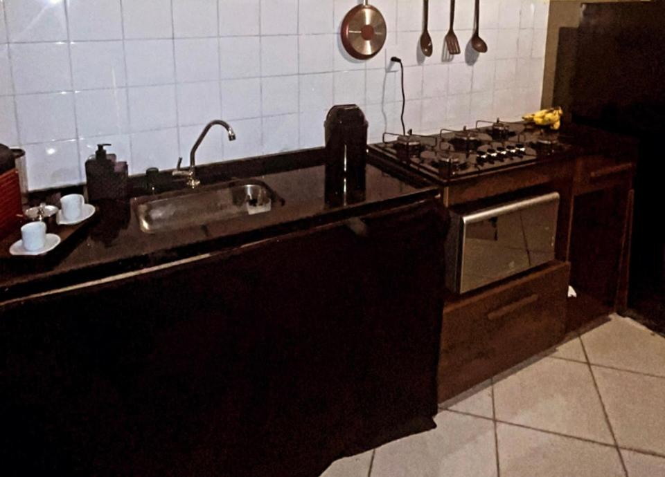 a kitchen with a sink and a stove at Savassi Hostel in Belo Horizonte