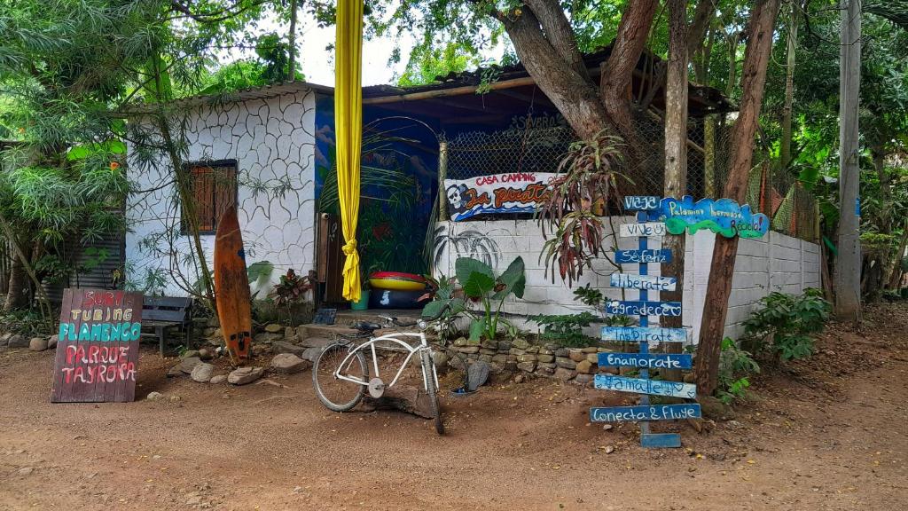a small building with signs in front of it at LA PIRATA Casa Hostel in Palomino