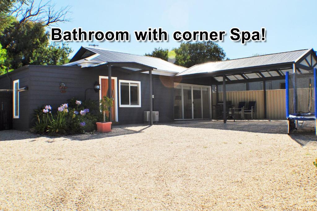 a building with a corner yard with a playground at LUXURIOUS Couples Escape, SPA BATH, Netflix, NBN in Victor Harbor