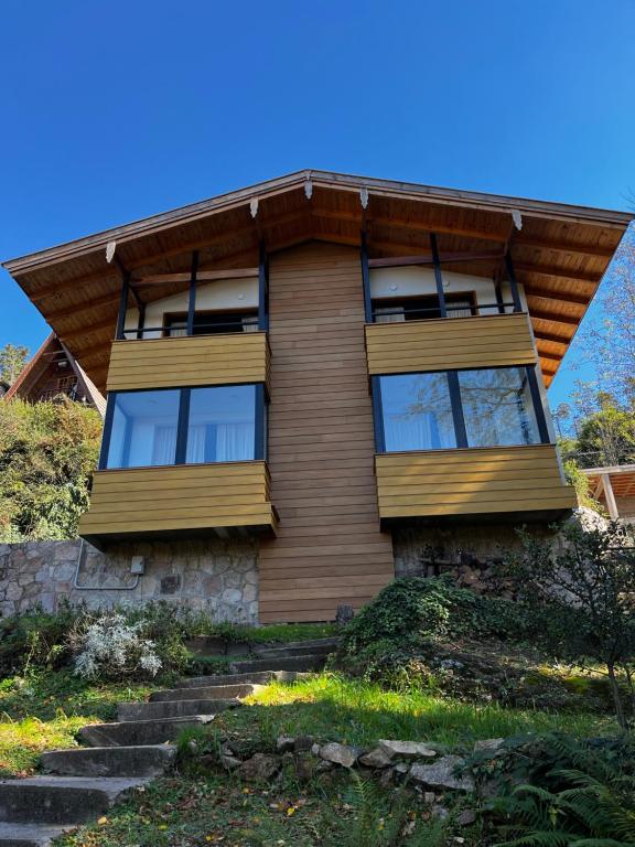 a house with stairs leading up to it at Casa Raíz Cumbrecita in La Cumbrecita