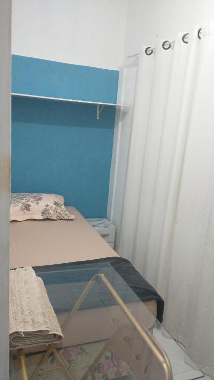a small room with a bed and a curtain at Hostel 940 in Sinop