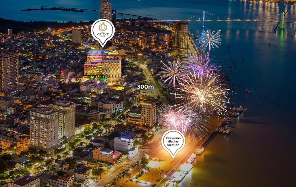 an aerial view of a city at night with fireworks at New Orient Hotel Da Nang in Da Nang