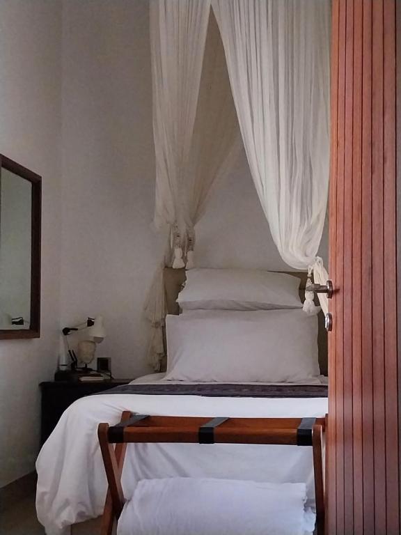 Postel nebo postele na pokoji v ubytování Dim House Jimbaran