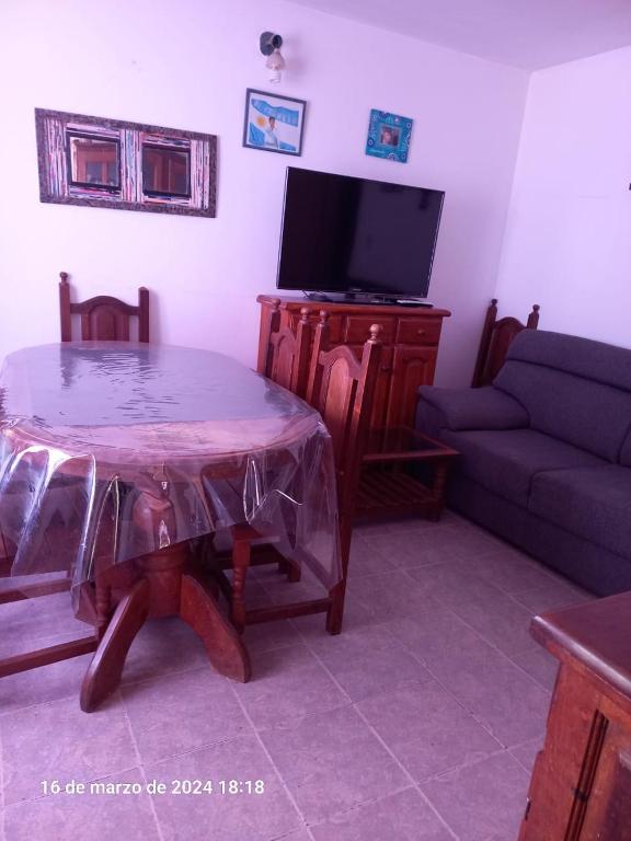 a living room with a table and a couch at Alquiler Jano in Tecka