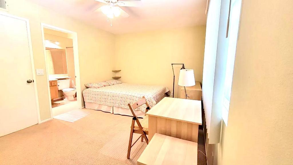 a bedroom with a bed and a desk and a lamp at Beysicair Vacation Homes in Calabasas