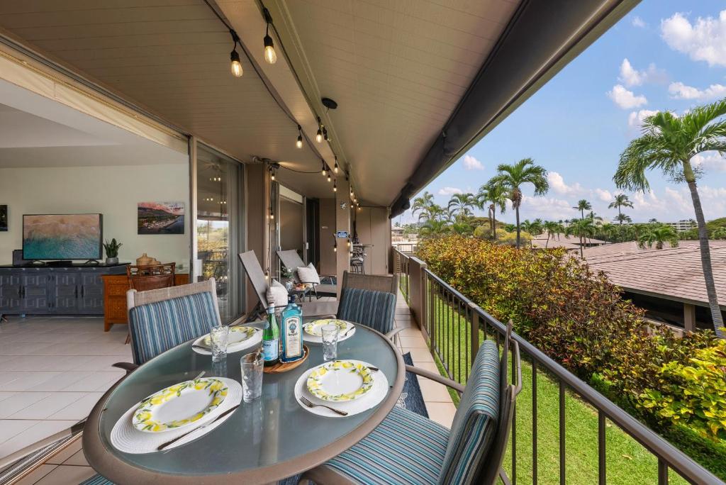 a table on a balcony with a view of the ocean at Eldorado L202 in Kahana