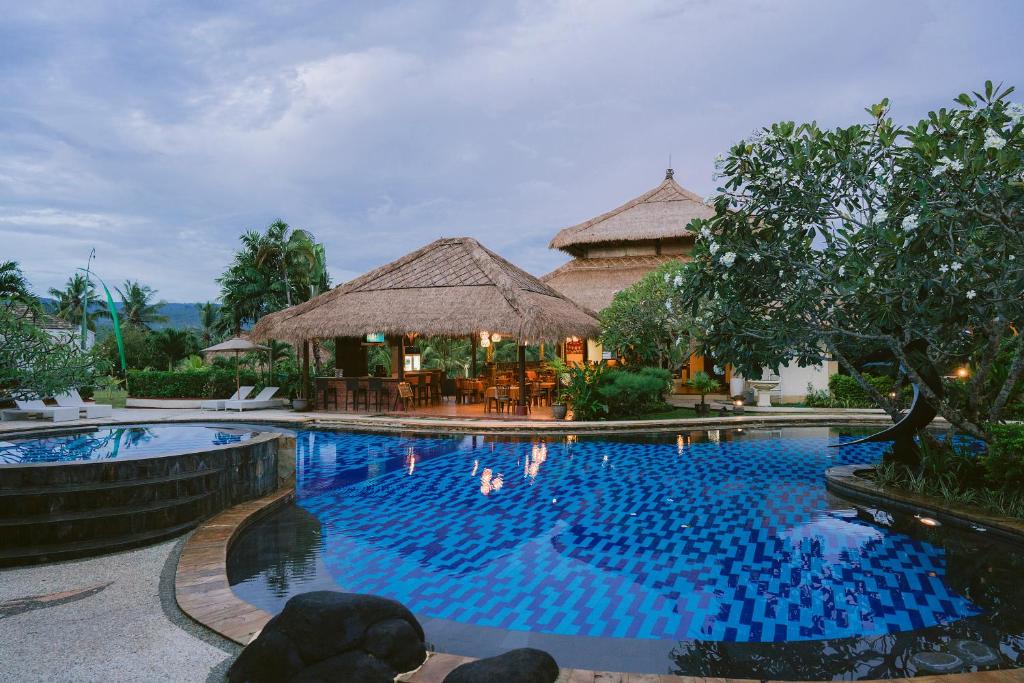 a swimming pool in front of a resort at Medewi Bay Retreat in Pulukan