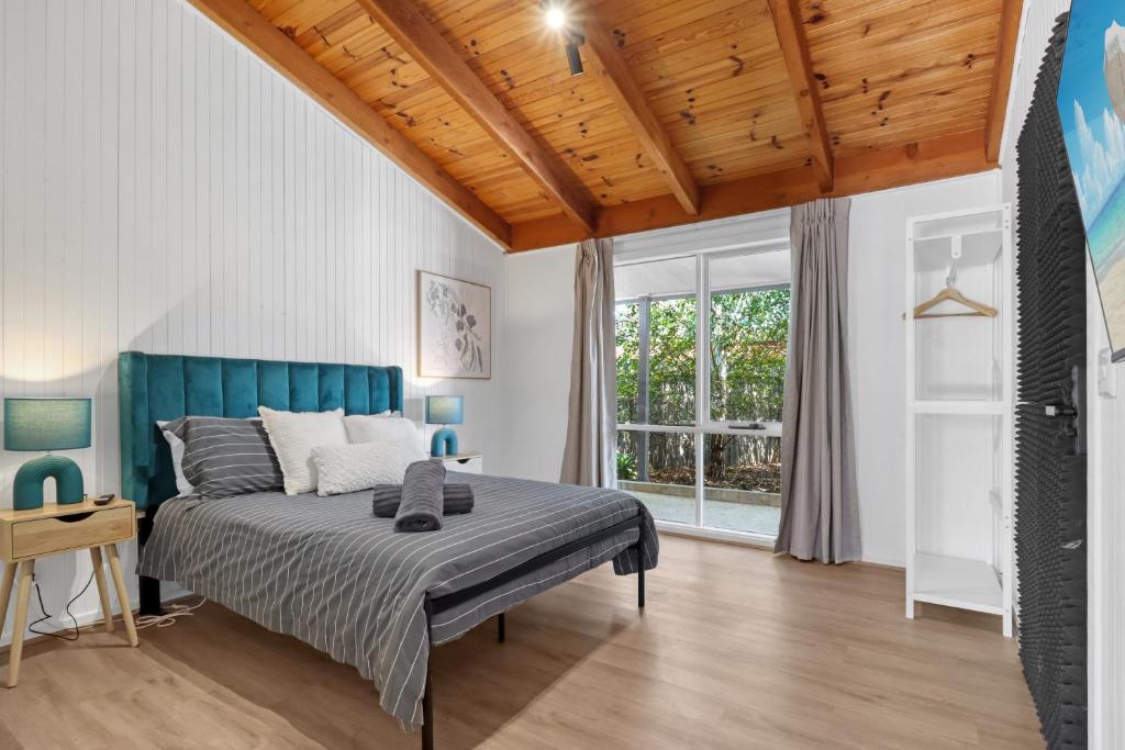 a bedroom with a bed and a wooden ceiling at Recharge in Waurn Ponds in Geelong