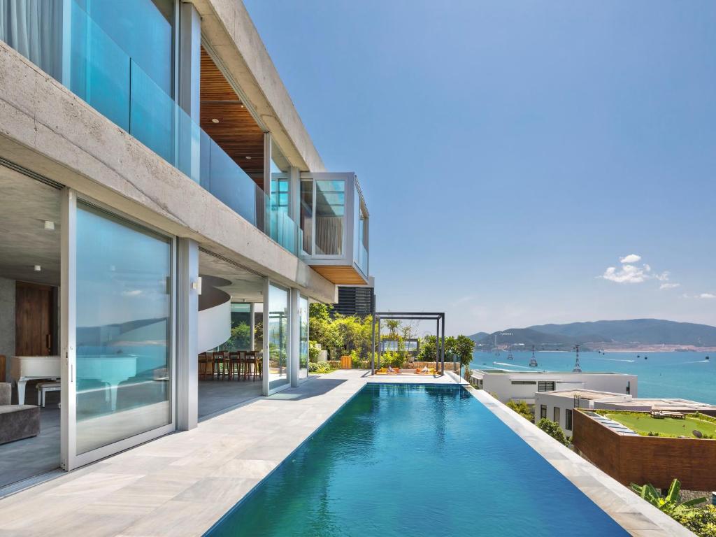 an external view of a house with a swimming pool at Venity Villa Nha Trang in Nha Trang