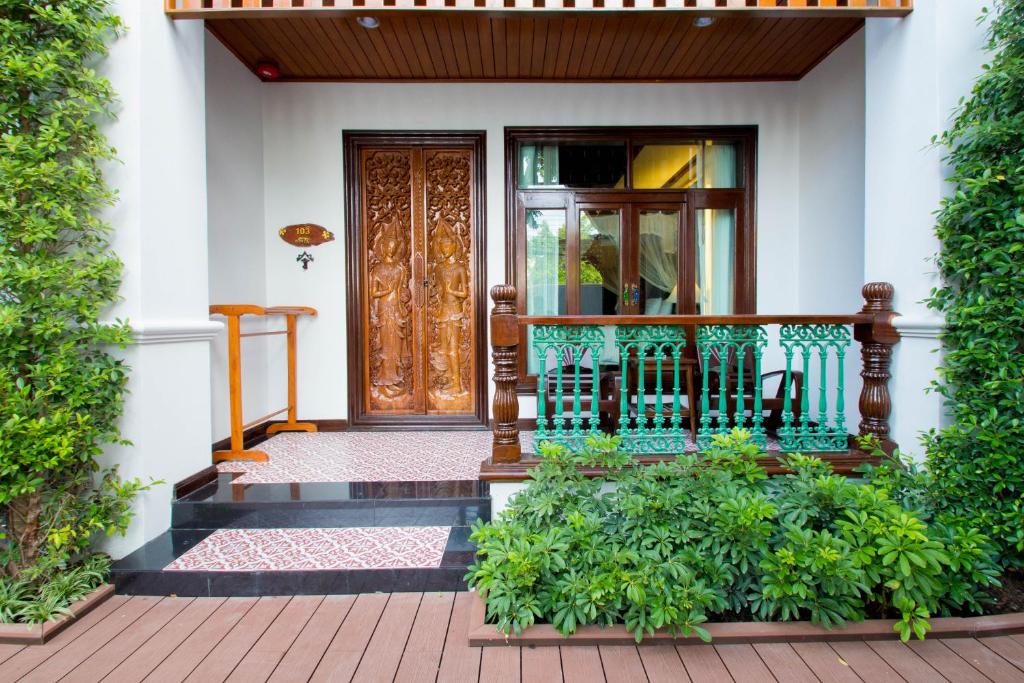 a front door of a house with a balcony at Villa Sirilanna Hotel in Chiang Mai