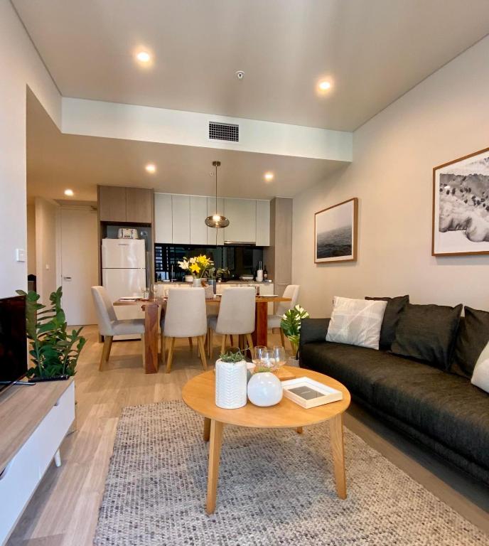 a living room with a couch and a table at YORK 1903 Self Catering in Sydney