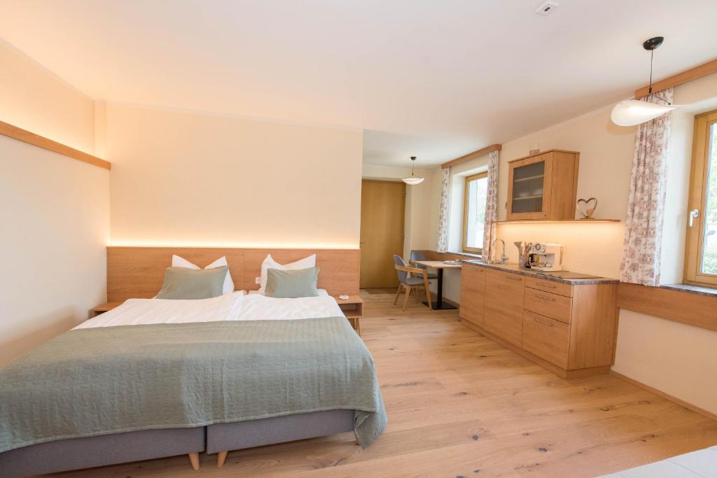 a bedroom with a large bed and a desk at Naturparkbauernhof Pöltl in Pöllau