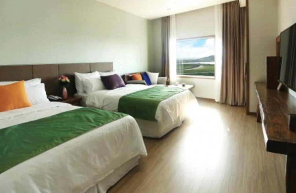 Postel nebo postele na pokoji v ubytování Login Hotel