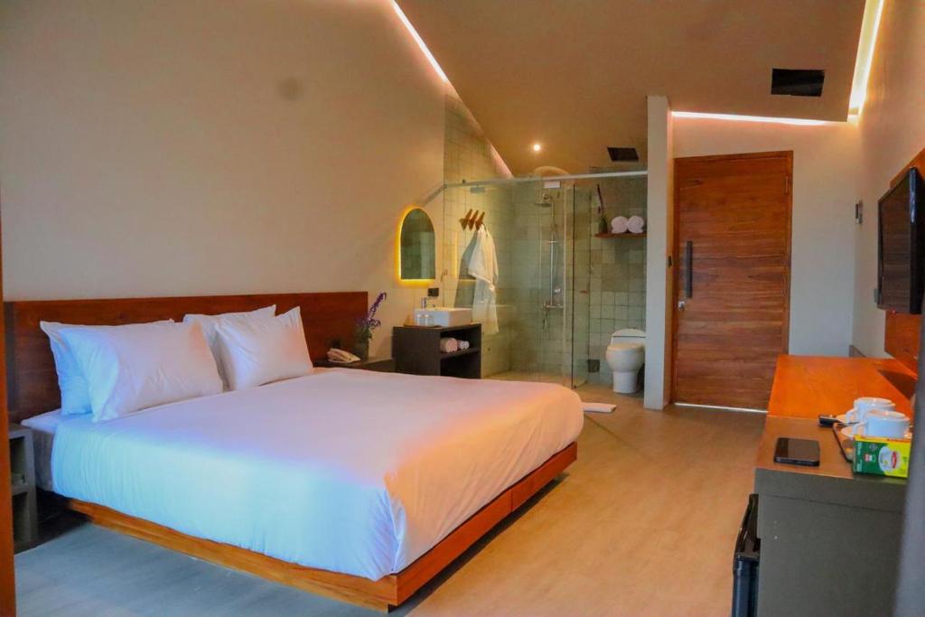 Katil atau katil-katil dalam bilik di Agua Hotel