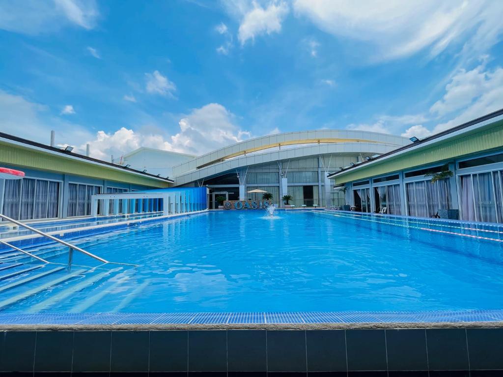 a large swimming pool in front of a building at LM METRO HOTEL in Zamboanga