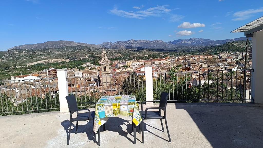a table and chairs with a view of a city at El Mirador"Venerable Escuder" in Cocentaina