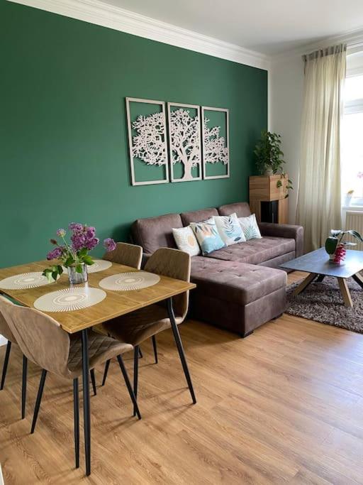 a living room with a couch and a table at 2-Zimmer Zentral in Ferdinandshof, WLAN Modern in Ferdinandshof