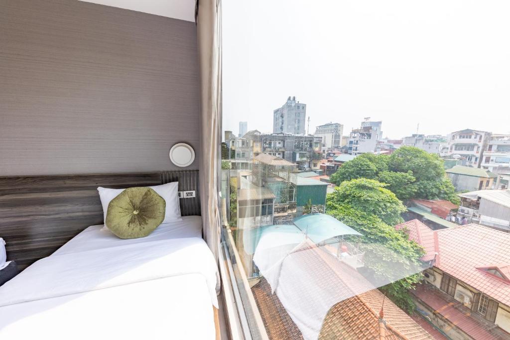 Postel nebo postele na pokoji v ubytování 3T Hotel Hanoi